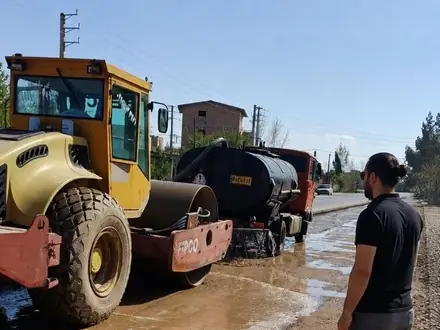 Roller and paver laying the asphalt course